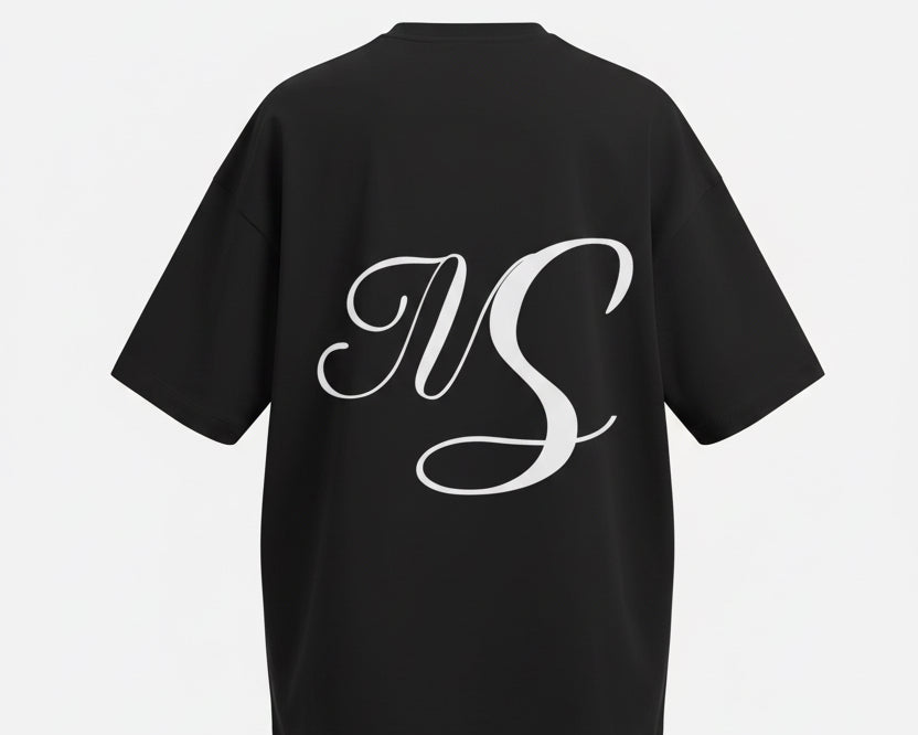 A black short-sleeve t-shirt with a large white cursive 'NS' monogram printed on the back, displayed against a light gray background.