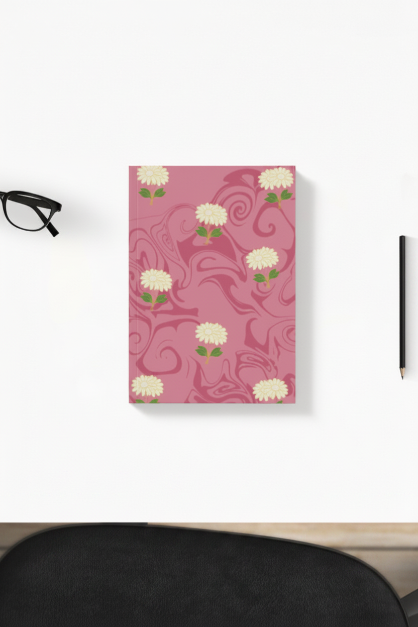 Cream daisy swirl pink pattern hardcover daily planner on a desk with glasses and pencil