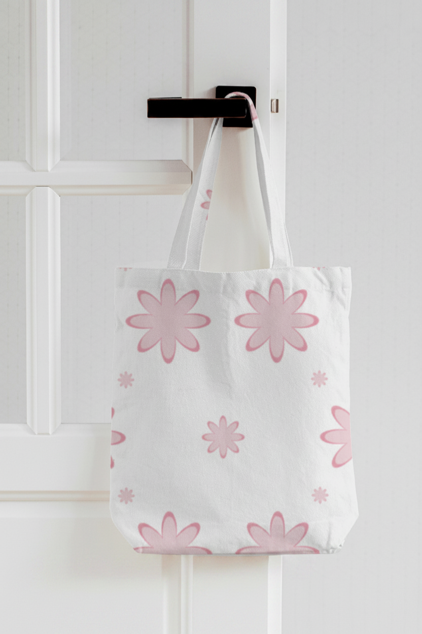 Pink floral all-over print zipper tote bag hanging on a white door hook